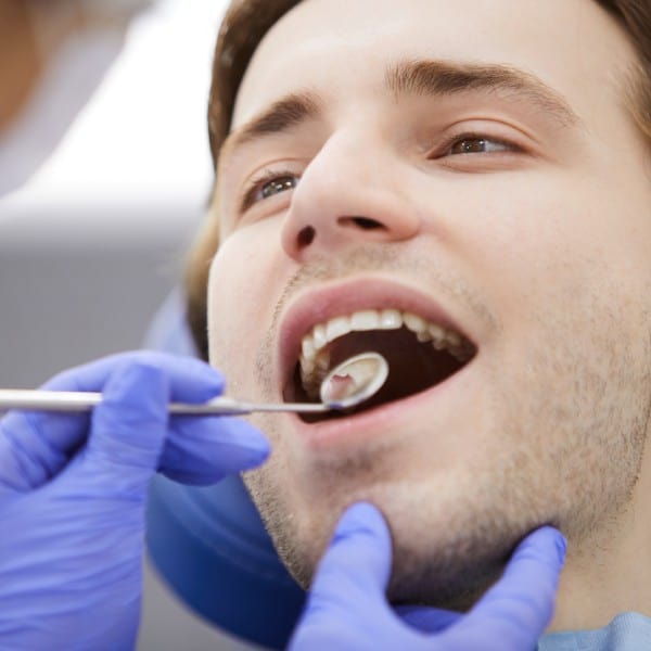 Man in dental chair - Newmarket Dentists by Oasispark Dental